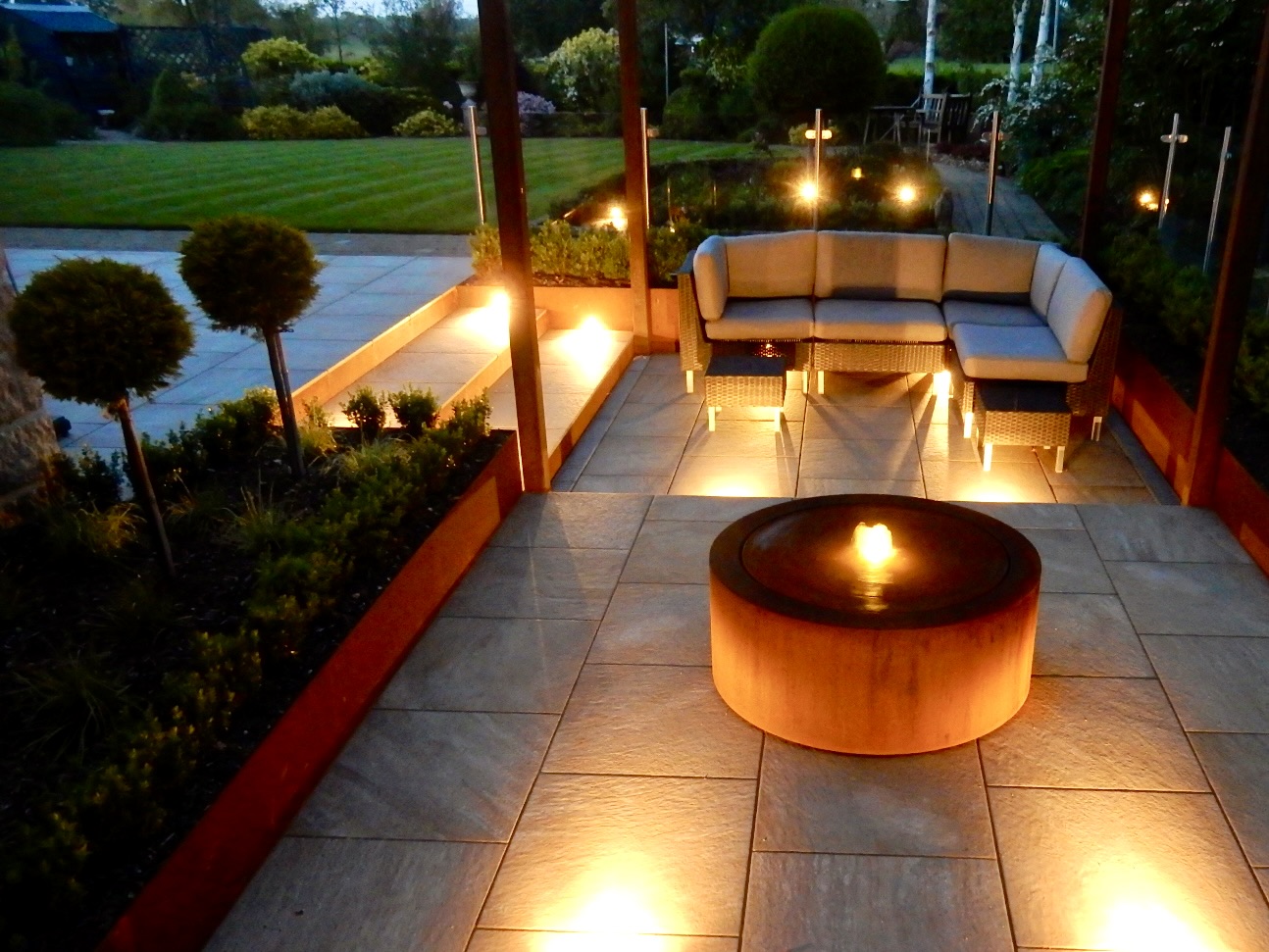A contemporary garden with water and lighting